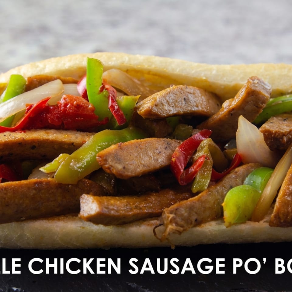 Andouille chicken sausage po’ boy topped with sautéed peppers and onions on a toasted hoagie roll.